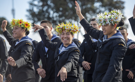 Royal New Zealand Navy sailors perform a Pacific Island dance at a Navy graduation ceremony 