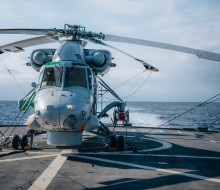 A Seasprite helicopter armed with a Penguin Missile sits on the flight deck of HMNZS Te Kaha.