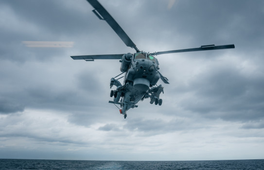A Navy Seasprite helicopter takes off from the flight deck of HMNZS Te Kaha.